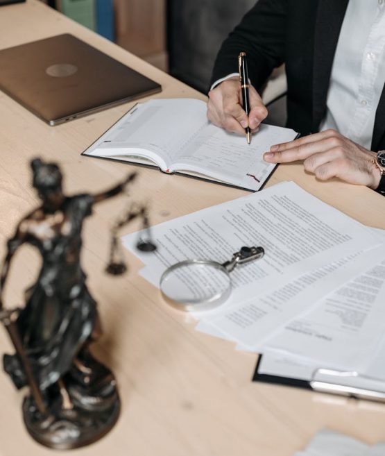 A Man Writing on a Notebook